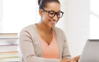 Woman studying and registering for her addiction counselor program.
