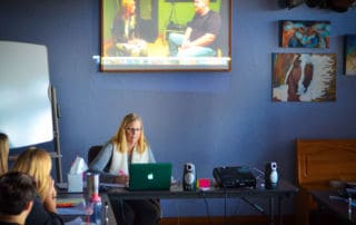 Class taking notes on counselor & patient interactions.