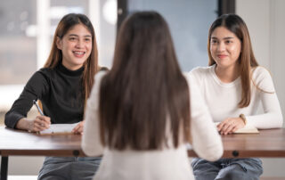 Addiction counselor/ advisor meet female students to advise their addiction counseling study.