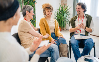 A group of people sitting in a circle with two addiction counselors